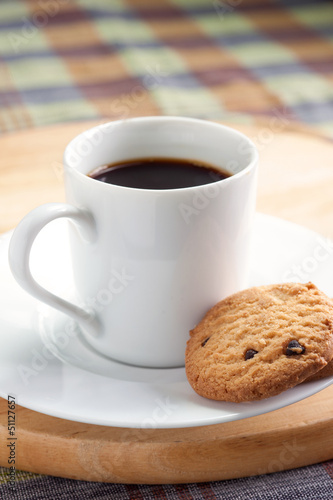 A cup of coffee with some cookies