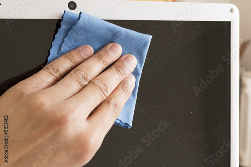 Cleaning a Flat screen with an antistatic cloth blue photo