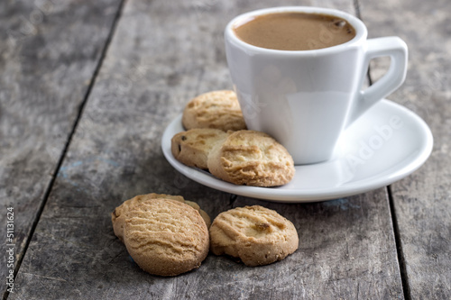 coffee cup and cookies on table