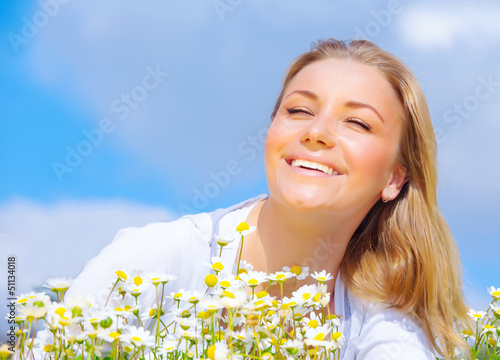 Young woman enjoying daisy field