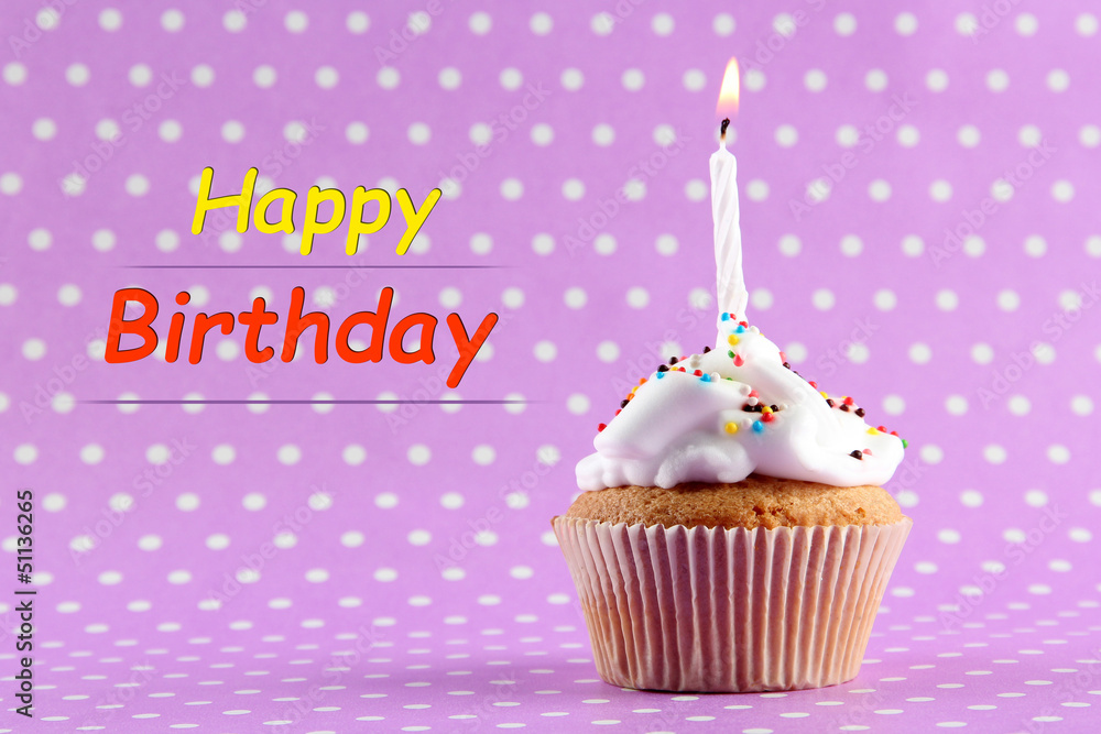 tasty birthday cupcake with candle, on purple background tasty birthday cupcake with candle, on purple background