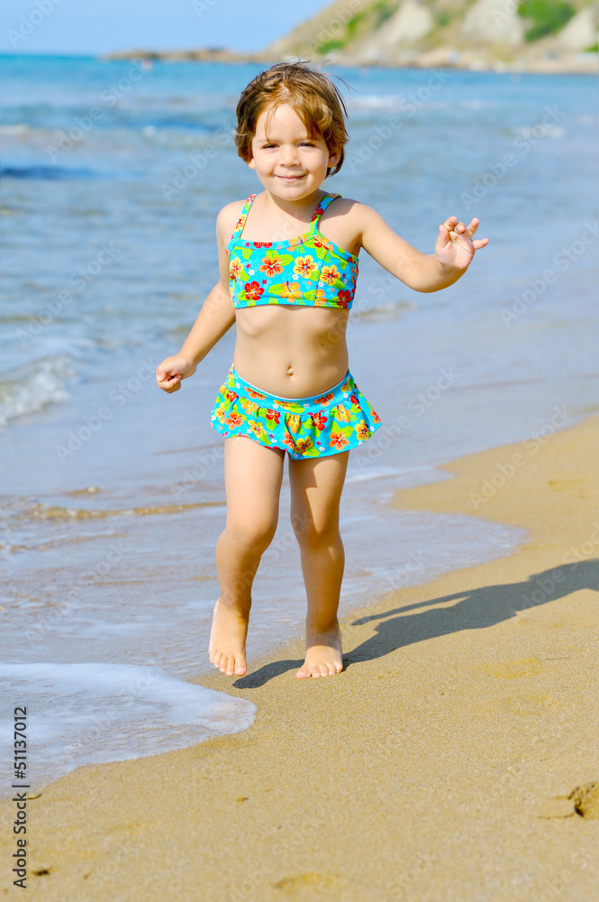 Happy toddler girl running on the beach Happy toddler girl running on the beach