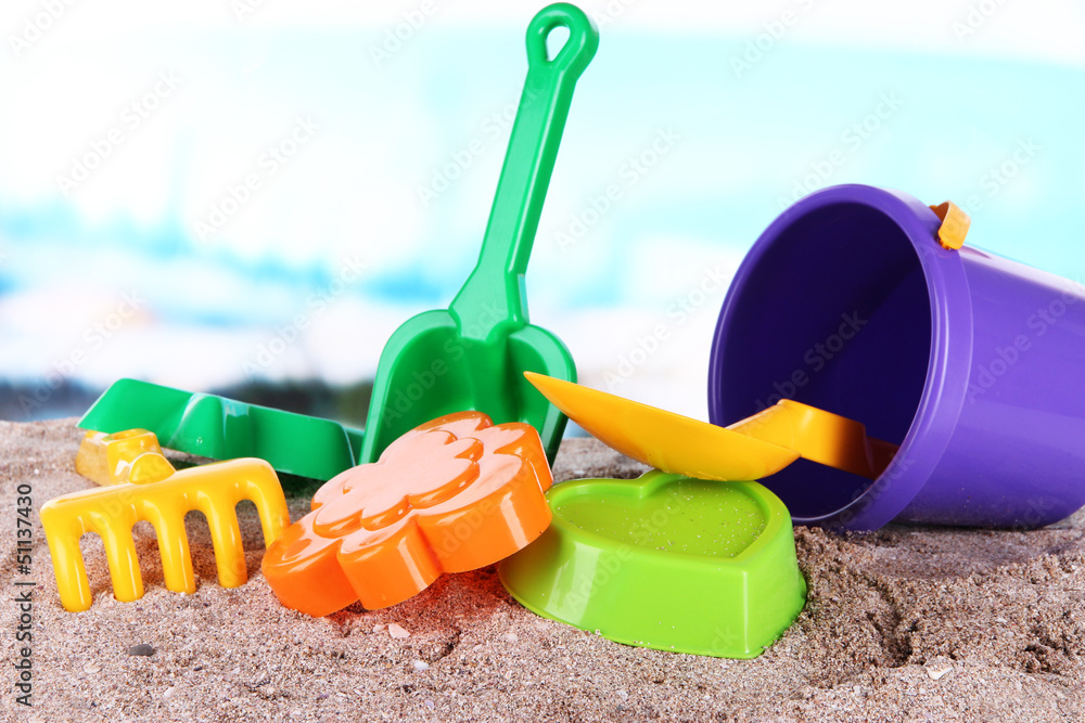 Children's toys on sand on sea background Children's toys on sand on sea background