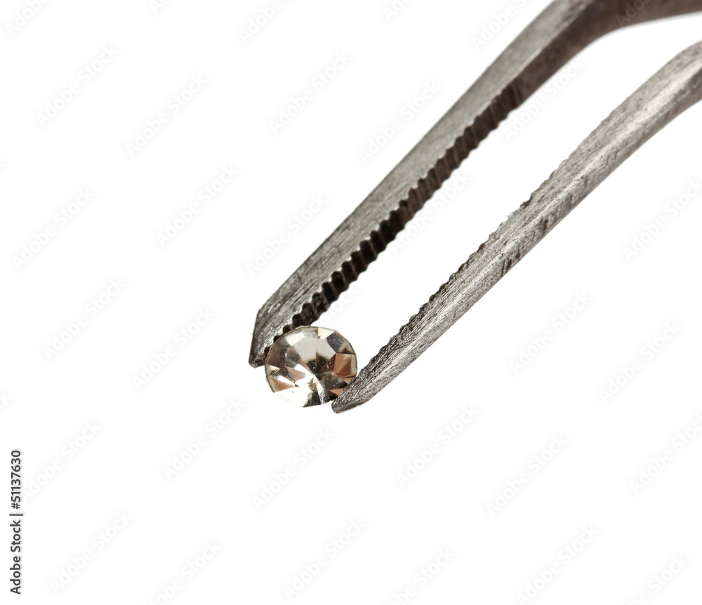 Beautiful shining crystal (diamond) in the tweezers,