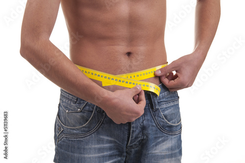 man measuring his waist photo