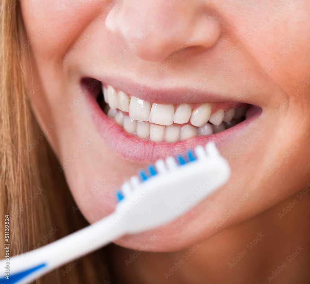 Fototapeta premium Woman Brushing Her Teeth