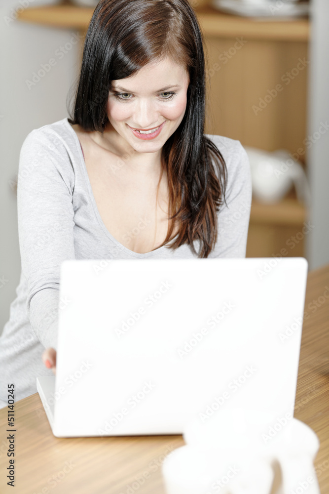 Woman using her laptop at home Woman using her laptop at home