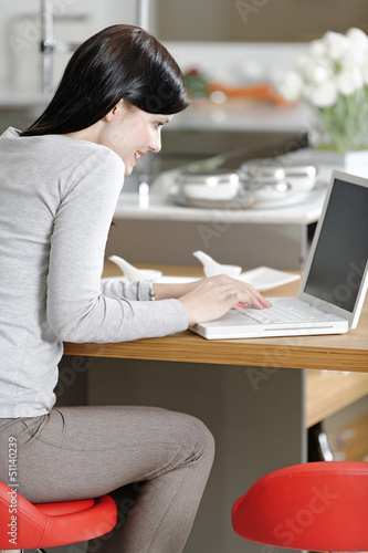 Woman using her laptop at home