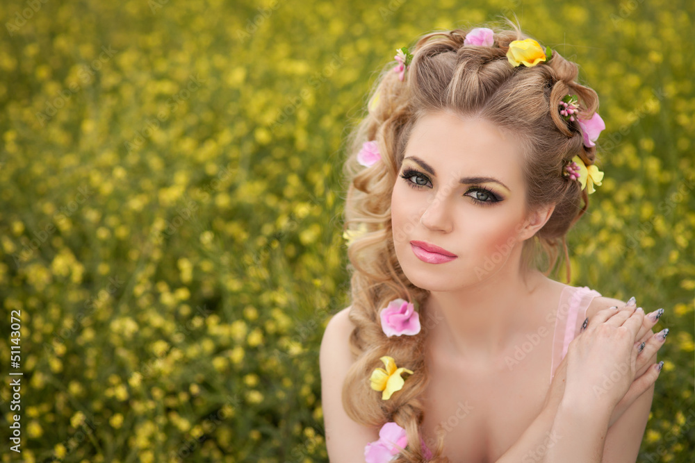 Beautiful blonde woman with hairstyle makeup sring flowers field Beautiful blonde woman with hairstyle makeup sring flowers field