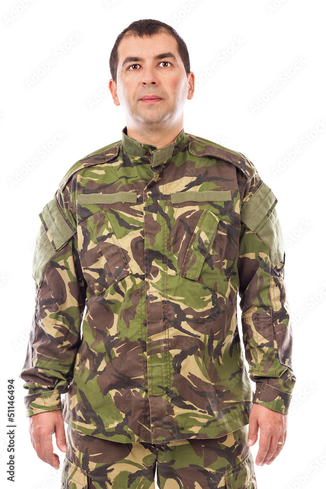 Portrait of a young soldier looking at camera isolated