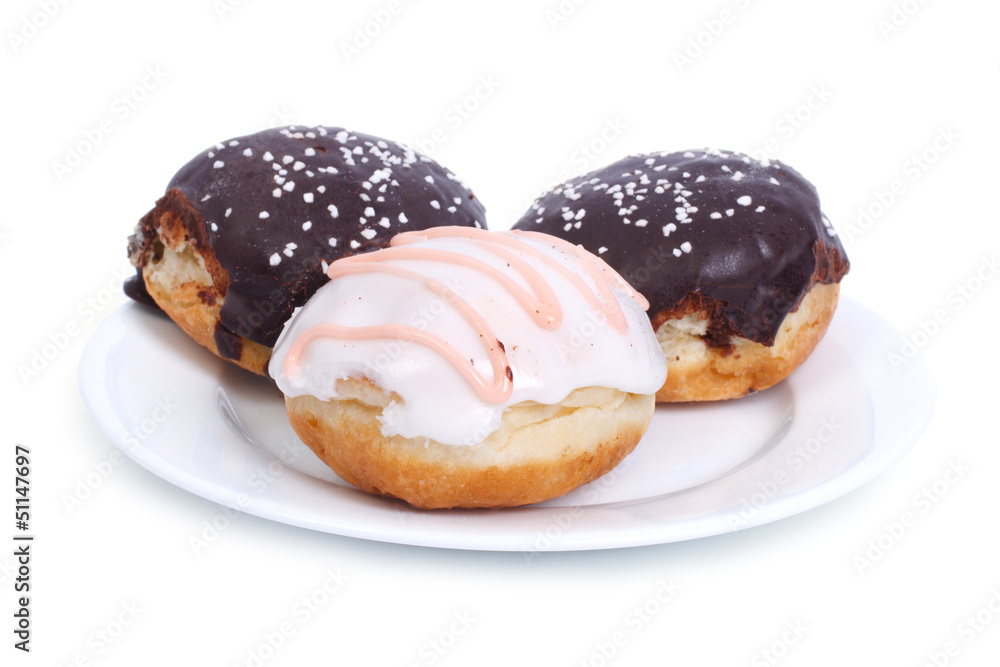 ree delicious donuts in the glaze isolated on a white plate
