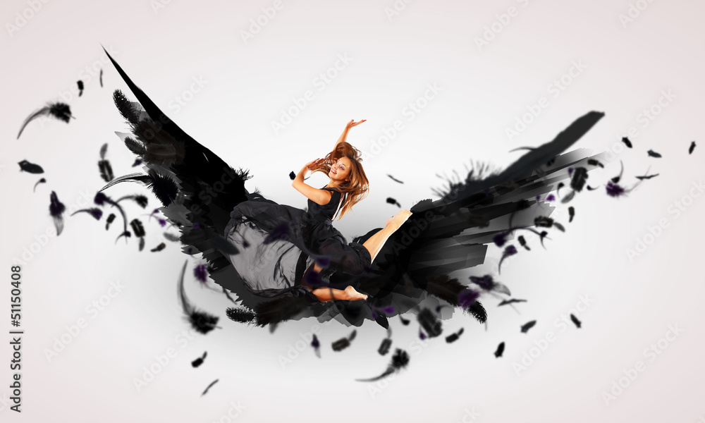 Fototapeta premium Woman floating on dark wings