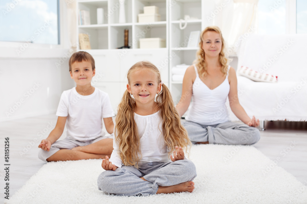 Kids doing yoga relaxing exercise Kids doing yoga relaxing exercise