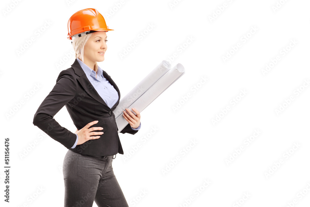 A female architect wearing an orange helmet and holding a bluepr A female architect wearing an orange helmet and holding a bluepr