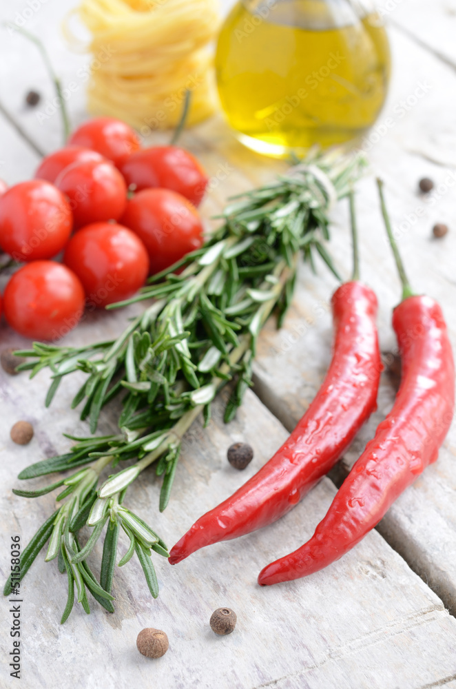 Italian ingredients - rosemary, olive oil, chilli, tomatoes