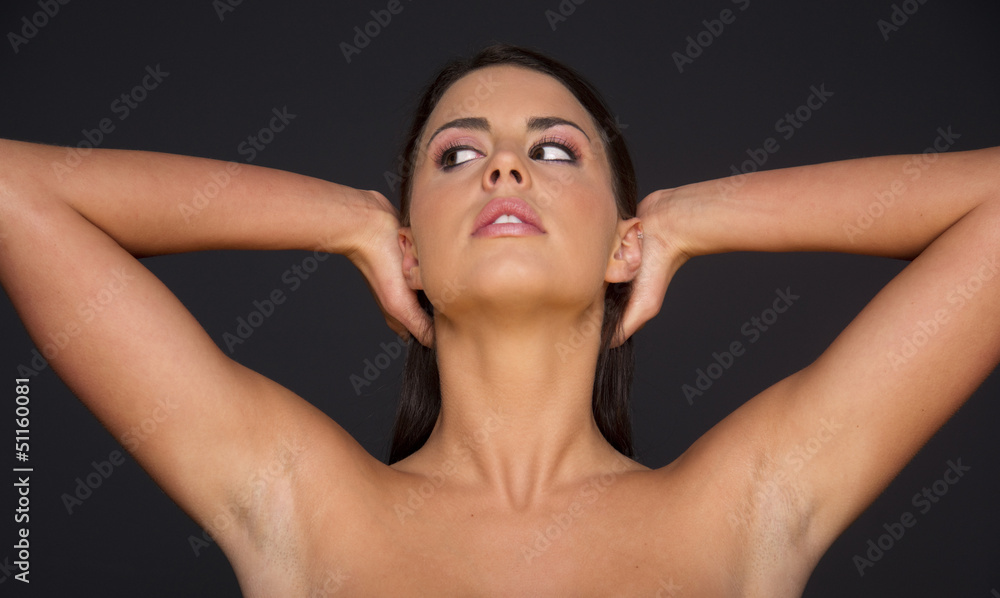 Obraz premium Woman Looks to The Side While Dressing and Creating Hairstyle