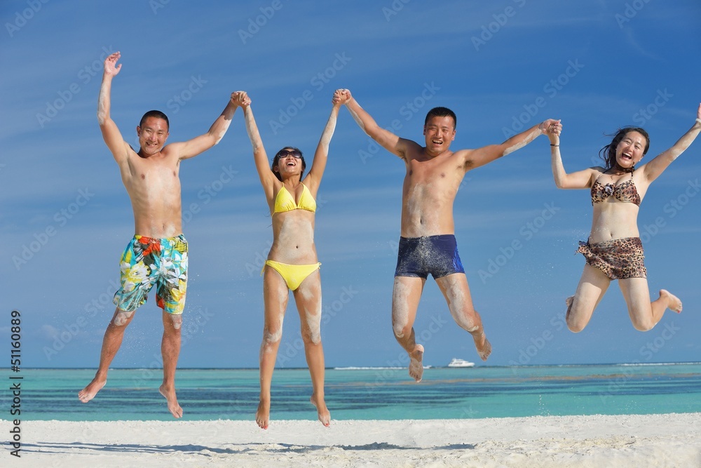 group of happy young people have fun on bach group of happy young people have fun on bach