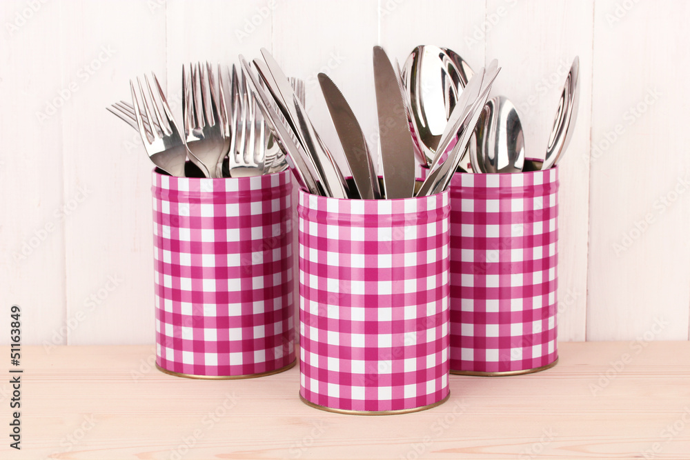 Utensils in metal containers isolated on light background Utensils in metal containers isolated on light background