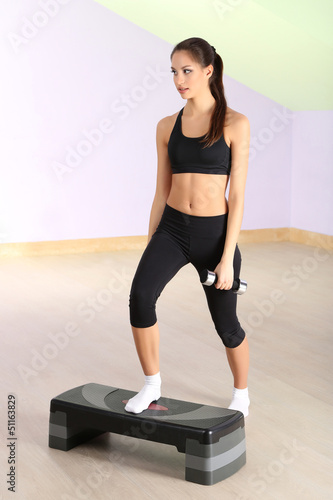 Young woman doing fitness e...