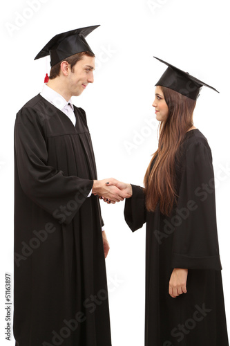 Two happy graduating students isolated on white