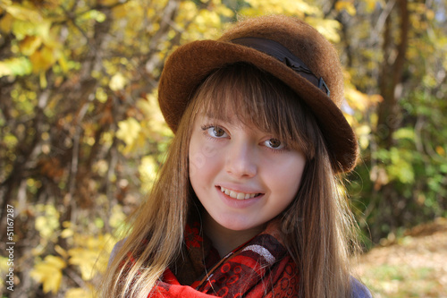 Smiling happy girl in autumn park.
