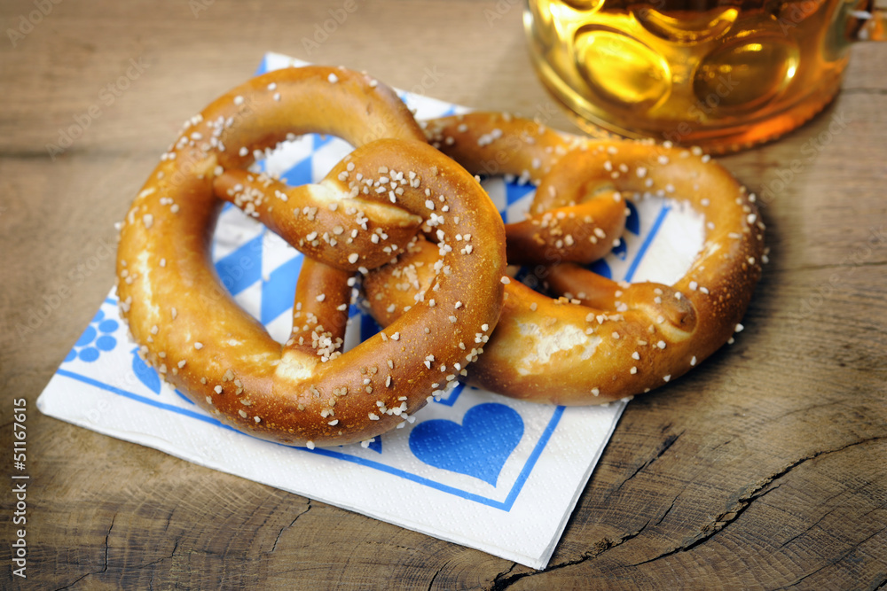 Pretzel and beer on bavarian napkin Pretzel and beer on bavarian napkin