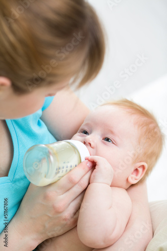 mother feeding baby from bo...