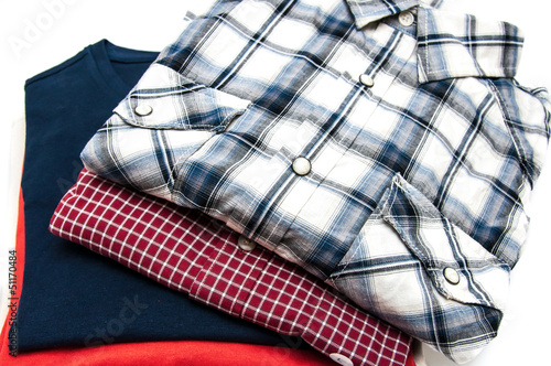 Stack of Shirts and T Shirts in different colors isolated