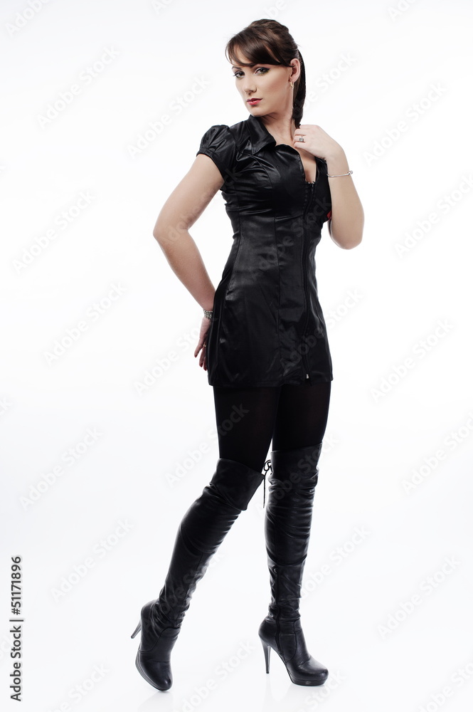 Sensual brunette in black tight dress on a light background Sensual brunette in black tight dress on a light background