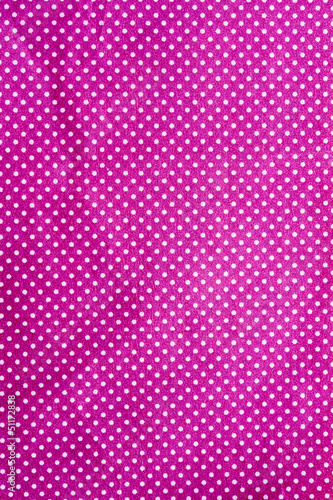 wrinkled purple cloth with a white dot