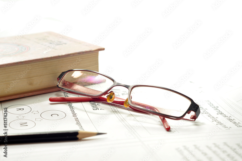 lying on the bookshelf with a glasses lying on the bookshelf with a glasses