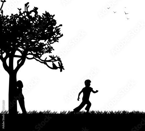 Children playing hide and seek in the park silhouette