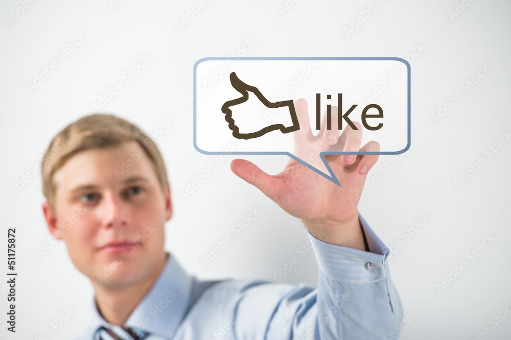 Business man touching social media button with thumb up symbol o Business man touching social media button with thumb up symbol o