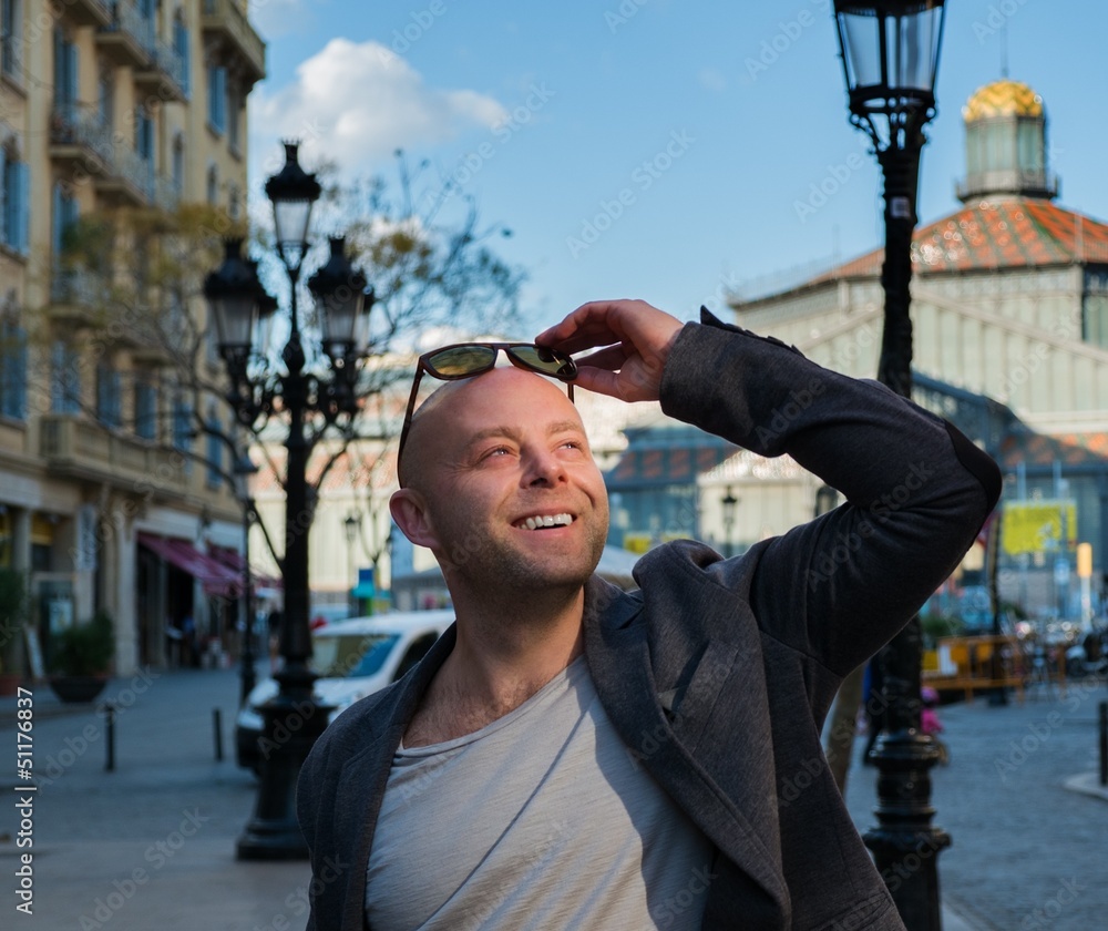 Fototapeta premium Smiling middle-aged man wearing jacket outdoors