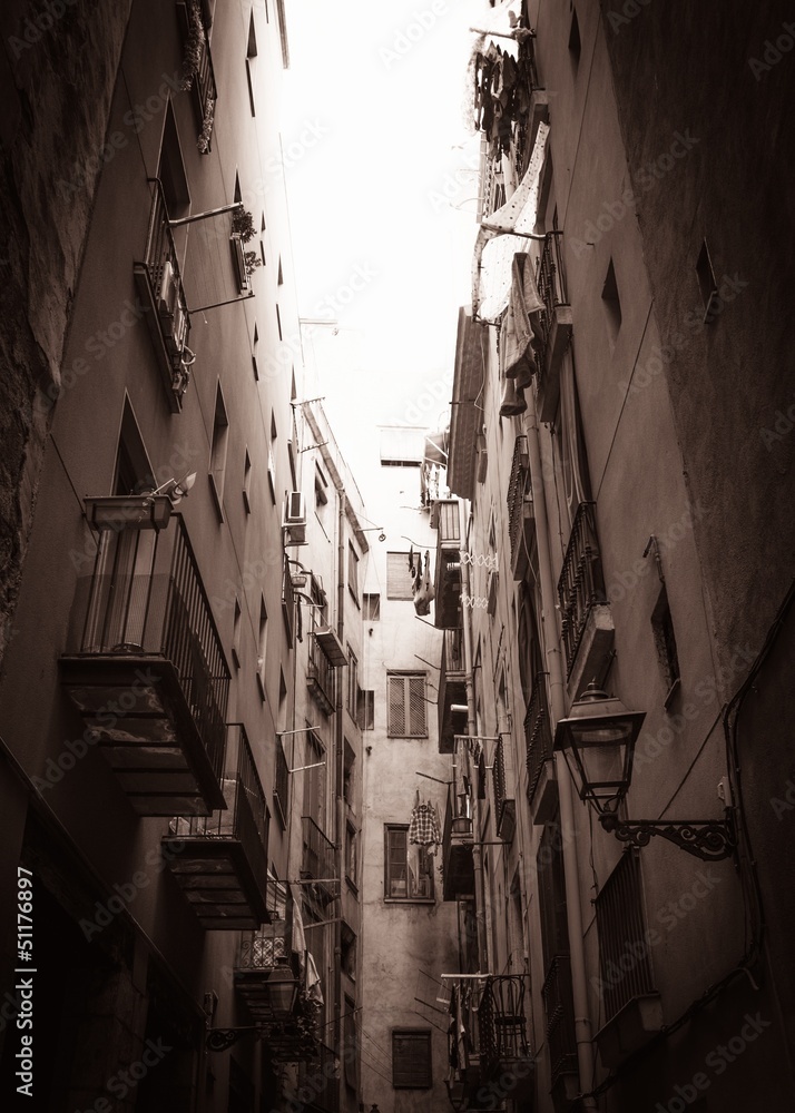 Sepia picture of narrow street end with balconies