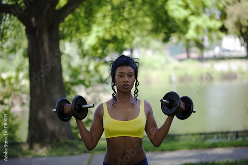 Young Black Woman In Park With Weights