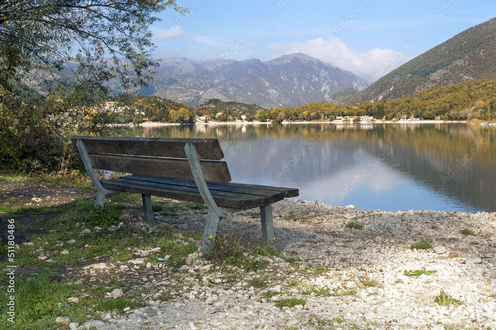 Wooden bench along the riverside, Lake Scanno, Abruzzo, Italy