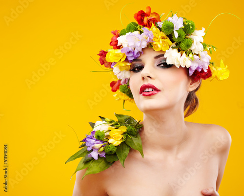 Woman with hairstyle and flower. Isolated on yellow