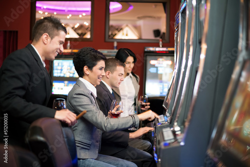 young people gambling in the casino on slot machines