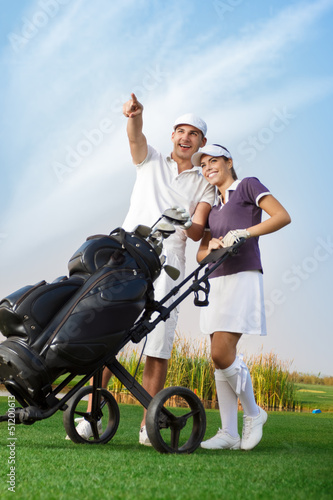 Young couple with golf bag