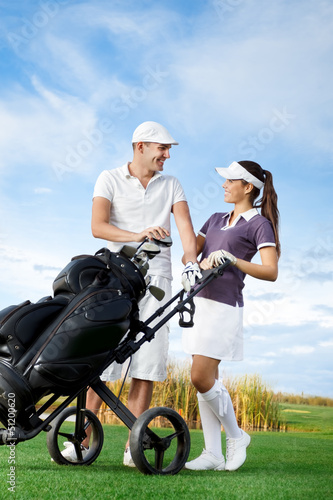 Couple playing golf on a sunny day