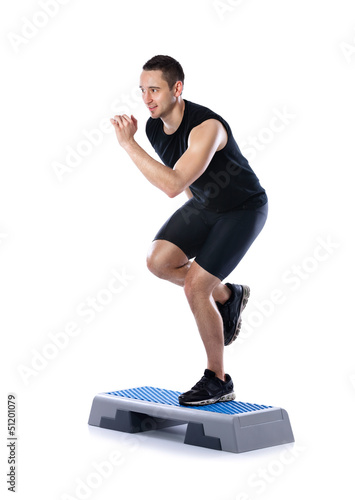 Obraz na płótnie young male doing step exercise