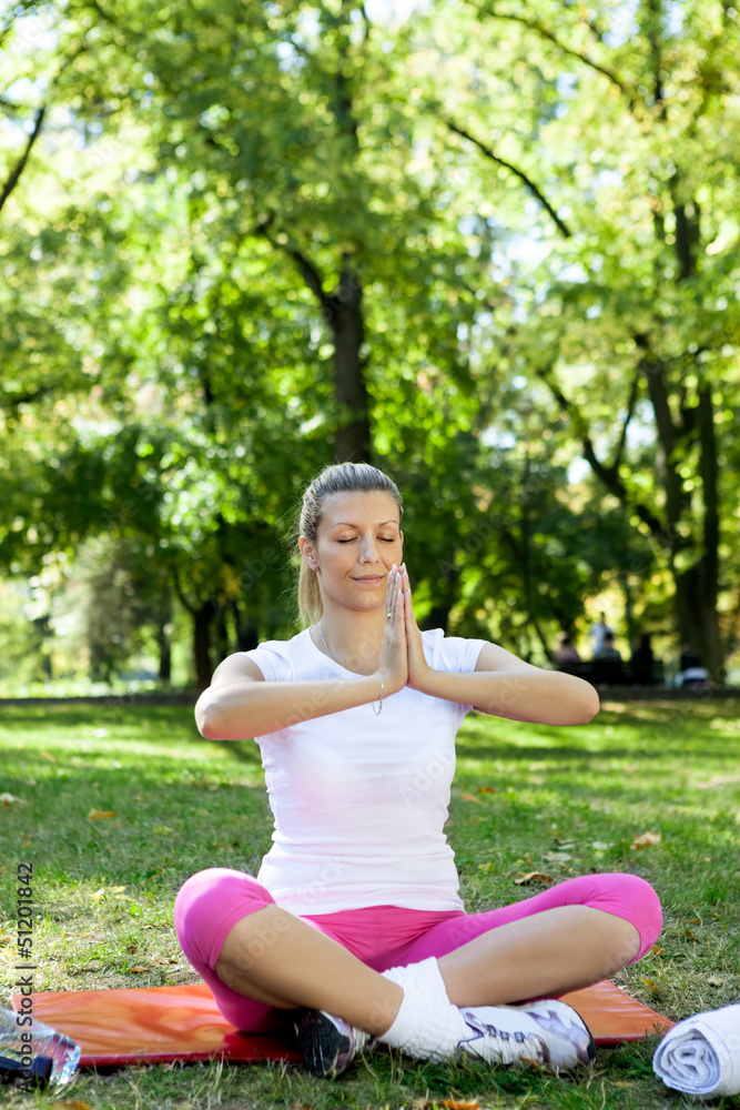 Young woman meditating in park