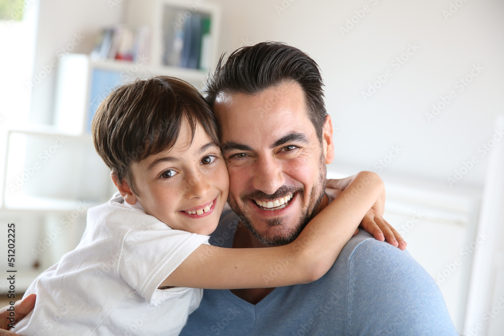 Portrait of father and son relaxing at home Portrait of father and son relaxing at home