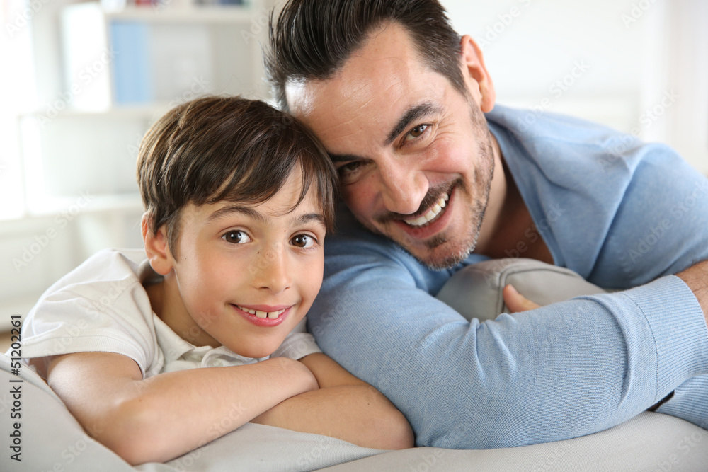 Portrait of father and son relaxing at home Portrait of father and son relaxing at home