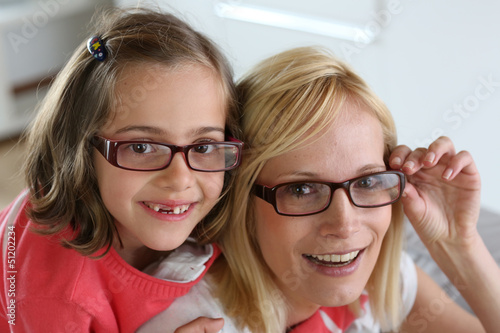 Mother and daughter with eyeglasses on