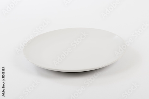 Empty white plate on a white background.