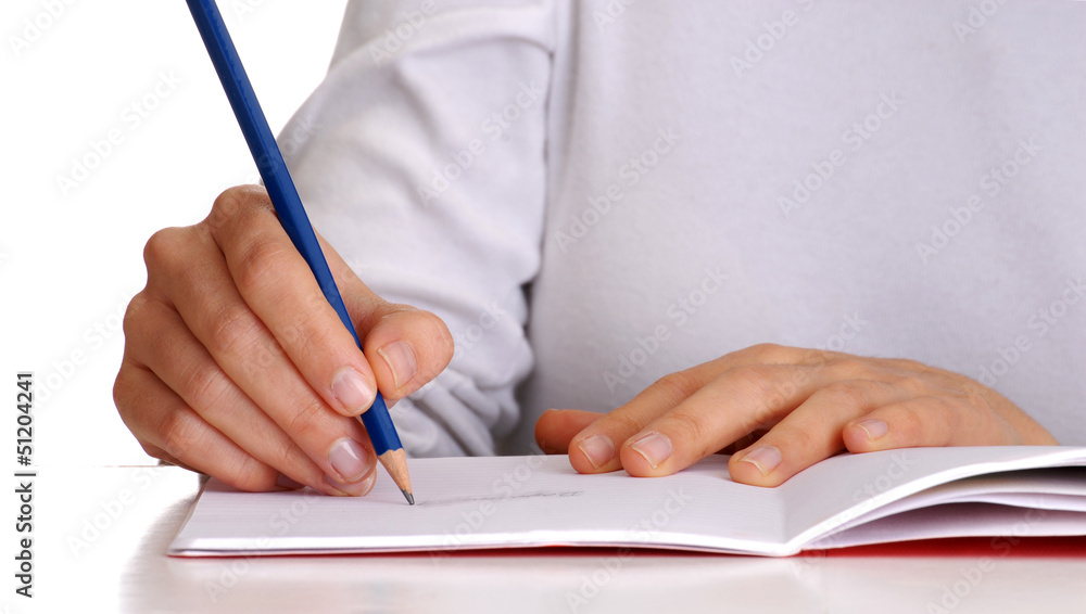 Manos escribiendo sobre un cuaderno. Manos escribiendo sobre un cuaderno.