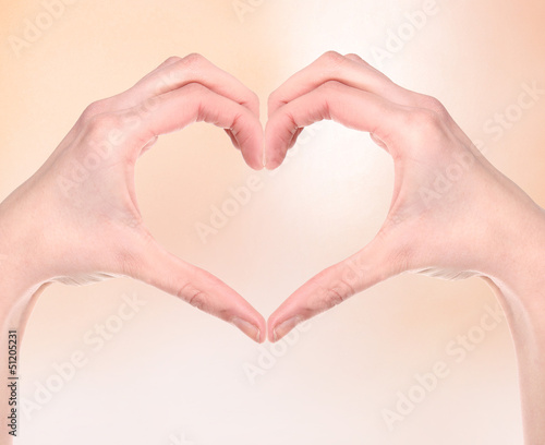 Woman hand making sign Heart