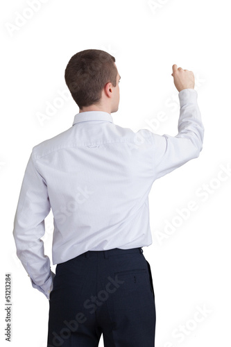 back of a young businessman writing on a white wall